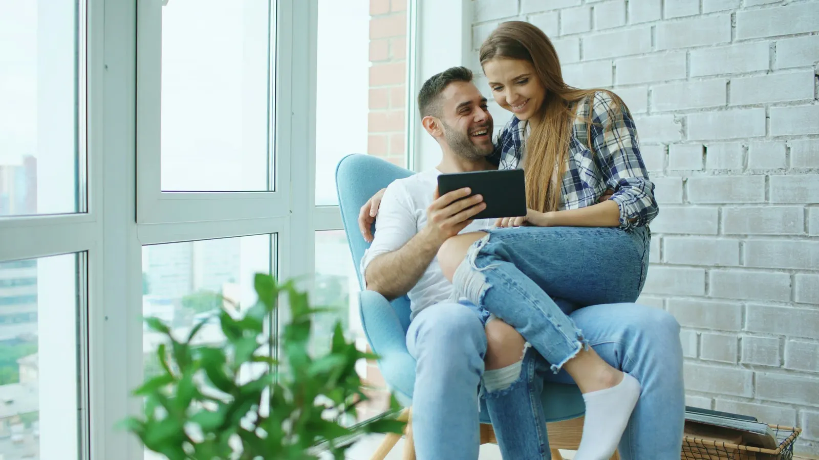 Home buyers reviewing listings on a tablet